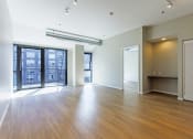 Thumbnail 36 of 41 - an empty living room with hardwood floors and a balcony