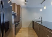 Thumbnail 35 of 41 - a kitchen with wooden cabinets and stainless steel appliances