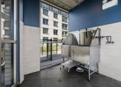 Thumbnail 12 of 33 - a large stainless steel tub sits in the corner of a room with a balcony in the background at Lakeview 3200 Apartments, Illinois, 60657