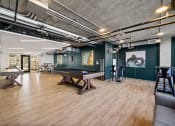 Thumbnail 22 of 33 - a game room with a ping pong table and a foosball table at Lakeview 3200 Apartments, Illinois