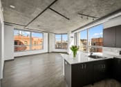 Thumbnail 1 of 33 - a kitchen with a large window and a view of a city at Lakeview 3200 Apartments, Chicago