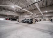 Thumbnail 18 of 34 - a parking garage with cars parked in it