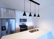 Thumbnail 32 of 34 - a kitchen with a sink and a refrigerator