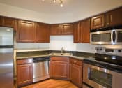 Thumbnail 6 of 16 - Kitchen with cabinets at Versailles on the Lakes Schaumburg, Schaumburg, IL