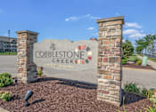 Thumbnail 1 of 3 - Cobblestone creek sign in front of a building.