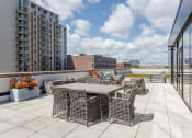 Thumbnail 29 of 41 - an outdoor terrace with tables and chairs on a sunny day