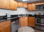 Thumbnail 15 of 30 - Upgraded Kitchen with wooden cabinets and appliances at Versailles on the Lakes Oakbrook*, Oakbrook Terrace, IL