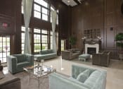 Thumbnail 12 of 16 - Living room couch and fire place at Versailles on the Lakes Schaumburg, Schaumburg, IL, 60173