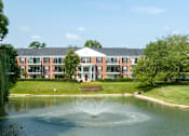 Thumbnail 2 of 30 - A building with a fountain in front of it at Versailles on the Lakes Oakbrook*, Illinois