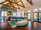 Thumbnail 22 of 32 - The leasing offie at Fusion Crossroads with a white couch and a wooden floor at 1601 Eastchase Pkwy in Fort Worth, TX.
