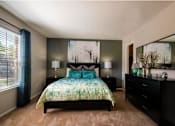 Thumbnail 2 of 32 - An apartment bedroom with a large bed and a dresser at 1601 Eastchase Pkwy in Fort Worth, TX.