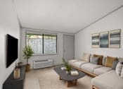 Thumbnail 6 of 36 - Retreat at Indian Lake apartments in Hendersonville, TN living room with a grey couch, a black coffee table, and a flat screen TV mounted on the wall.