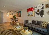 Thumbnail 3 of 25 - Open concept living room in the Canvas Apartments 2 bedroom apartments Nashville and dining nook with midcentury modern luxury decor.