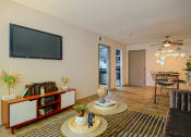Thumbnail 4 of 25 - Nashville apartments to rent - open concept living room at the Canvas Apartments and dining room with two archways into kitchen and luxury wood style floors.