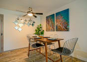 Thumbnail 6 of 25 - Prime apartments in Nashville - dining area in the Canvas Apartments in Nashville, tn with modern ceiling fan, bar-height table, and two abstract canvas paintings.