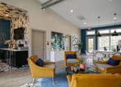 Thumbnail 33 of 49 - The Retreat apts at Indian Lake  lobby in hendersonville with midcentury modern seating area and coffee corner with TV.