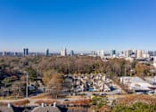 Thumbnail 18 of 18 - A cityscape with buildings and trees in the foreground at Fusion Buckhead Atlanta.