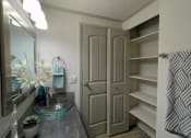 Thumbnail 16 of 49 - Bathroom in the Retreat at Indian Lake one bedroom apartment in Hendersonville with large linen closet and bi-fold doors.