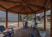 Thumbnail 17 of 37 - Fusion 35 wooden gazebo with a circular brick patio and four chairs.