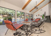 Thumbnail 29 of 37 - Fusion 35 clubhouse with a red chair and a black and white rug.