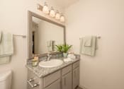 Thumbnail 9 of 37 - Fusion 35 bathroom with a sink, mirror, toilet and towels.