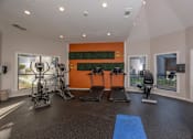 Thumbnail 25 of 37 - Fusion 35 gym with orange wall and exercise equipment.