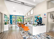 Thumbnail 15 of 36 - Retreat at Indian Lake Hendersonville TN leasing office with a white reception desk and orange chairs.
