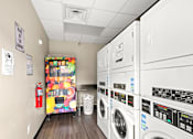 Thumbnail 19 of 36 - Retreat at Indian Lake Apartments Hendersonville TN laundry facility with a vending machine selling snacks.
