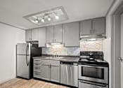 Thumbnail 8 of 36 - Retreat at Indian Lake Hendersonville TN apartments modern kitchen with stainless steel appliances and wooden flooring.