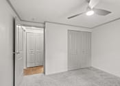Thumbnail 10 of 36 - Retreat at Indian Lake Hendersonville TN apartments bedroom with two doors and a ceiling fan.