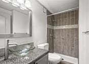 Thumbnail 11 of 36 - The Retreat at Indian Lake Apartments for rent in Hendersonville TN modern bathroom with a glass bowl sink and a walk-in shower.