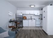 Thumbnail 11 of 43 - Kitchen in Fusion Fort Worth efficiency apartment in Haltom City with white cabinets, dishwasher, and electric stove and subway tile backsplash