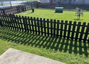 Thumbnail 27 of 43 - Pet Park at Fusion Fort Worth Apartments in Haltom City, Texas. Has lush green gras, agility toys for dogs, and pet waste station.