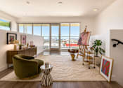 Thumbnail 5 of 52 - A loft room with a green chair and a painting on the easel.