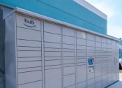 Thumbnail 20 of 23 - Fifteen 50 apartments Las Vegas amazon hub with screen and keypad in center in front of blue wooden plank wall