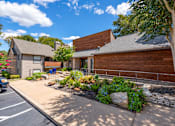Thumbnail 21 of 37 - Fusion 35 modern leasing office with a wooden exterior and a stone pathway leading to the front door.