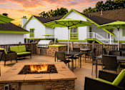 Thumbnail 10 of 18 - A patio with a fire pit and chairs at Fusion Buckhead.