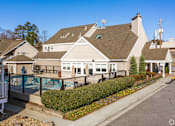 Thumbnail 15 of 18 - A residential area with apartments and a pool.