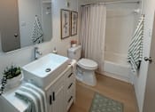 Thumbnail 10 of 36 - Fusion Crossroads bathroom with a white sink and toilet.