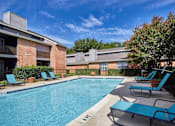 Thumbnail 12 of 32 - A pool surrounded by chairs and trees at 1601 Eastchase Pkwy in Fort Worth, TX.