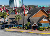 Thumbnail 34 of 41 - A building with the word Fusion on it is surrounded by palm trees.