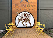 Thumbnail 36 of 43 - Fusion Fort Worth mural wall with wooden board with a star and a bull on it.