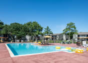 Thumbnail 22 of 43 - Fusion Fort Worth (previously Desert Sands) community swimming pool with large pool deck and yellow inflatables