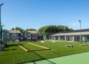 Thumbnail 31 of 43 - recreation lawn at fusion Fort Worth apartments in Haltom City, TX with corn hole and patio furniture