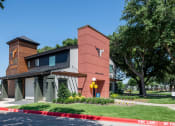 Thumbnail 39 of 43 - fusion Fort Worth leasing office with modern siding and awnings, green lawn, and large trees