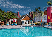 Thumbnail 20 of 41 - Fusion Orlando apartments pool with a wooden building in front of it.