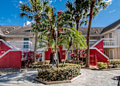 Thumbnail 36 of 41 - A red building with a palm tree in front at Fusion Orlando.