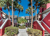 Thumbnail 37 of 41 - A red building with palm trees in front at Fusion Orlando.