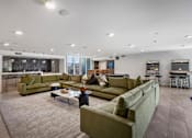 Thumbnail 36 of 52 - Fusion Hollywood luxury apartments with a large couch and a coffee table.