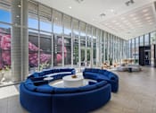 Thumbnail 50 of 52 - A large blue circular seating area with a white table in the middle.